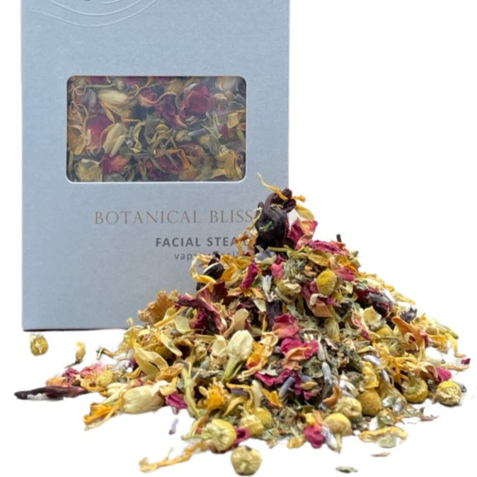 botanicals in a pile in front of a sealuxe box with the words botanical bliss facial steam