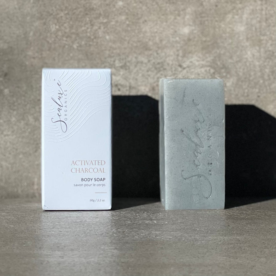 A sealuxe grey soap with a box beside it sitting in a shadow