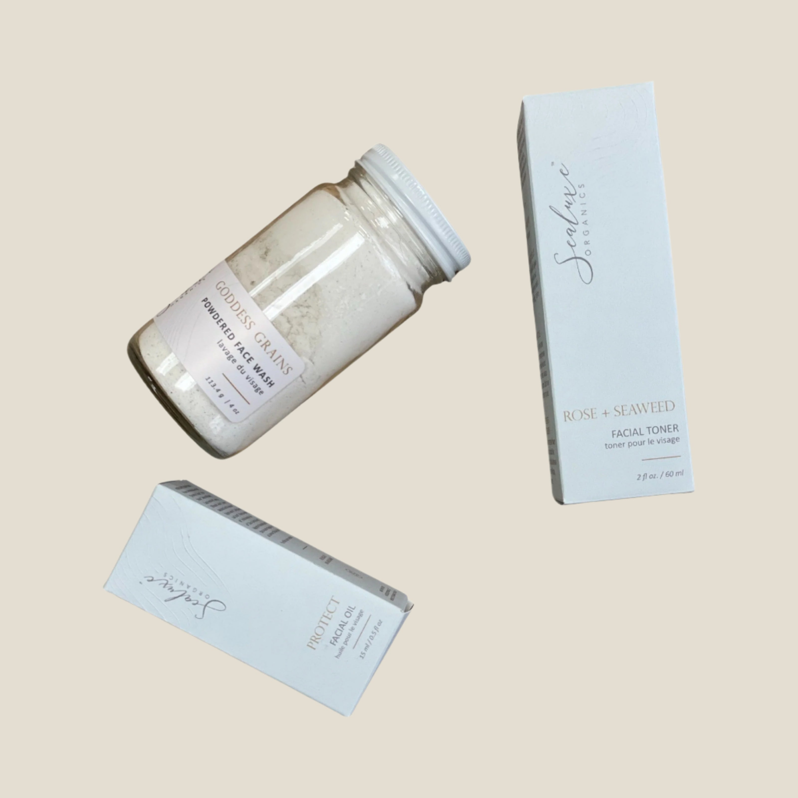 A set of three skincare products from Sealuxe, including a facial polish, antioxidant facial oil, and toner, packaged in a jar and two boxes.