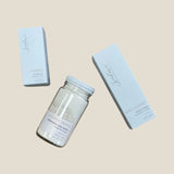 Three skincare products from Sealuxe, including a facial polish, facial oil, and toner, packaged in white containers with clear labels.