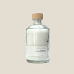 Bottle of Eucalyptus bath salts with a cork lid on a light gray background
