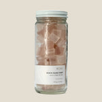 Jar of rose beach glass soap on a white background