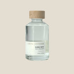 Bottle of lemon lavender bubble bath with a cork lid on a white background