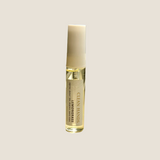 A small cylindrical roll-on bottle labeled 'CLEAN HANDS' and 'LEMONGRASS' stands on a windowsill with natural sunlight and a blurred window view in the background.