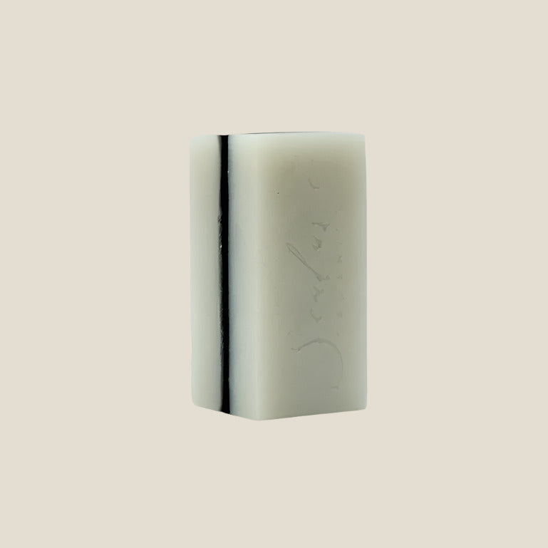 Rectangular bar of soap with engraved text on a white background