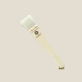 Paintbrush with wooden handle and white bristles on a light gray background