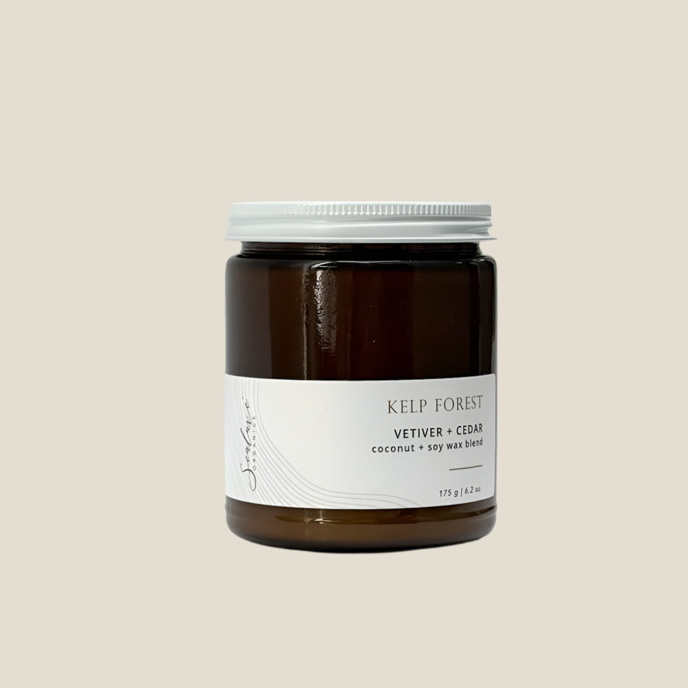 Candle jar labeled 'Kelp Forest' with vetiver and cedar on a white background