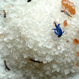 Close-up of white crystalline material with small colorful particles