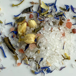 Assorted dried flowers and herbs on a white background
