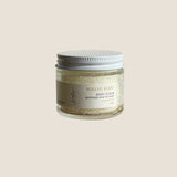 Jar of mulled berry body scrub on a wooden surface with a white background