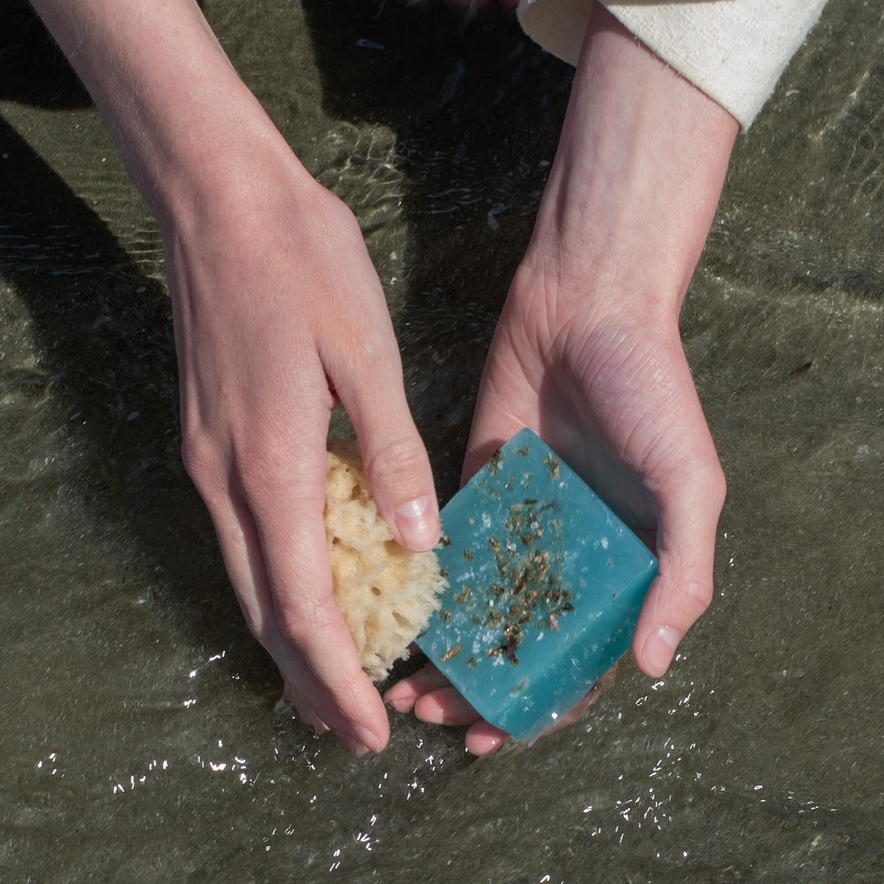 using sealuxe's seaweed and salt soap bar with a sea sponge