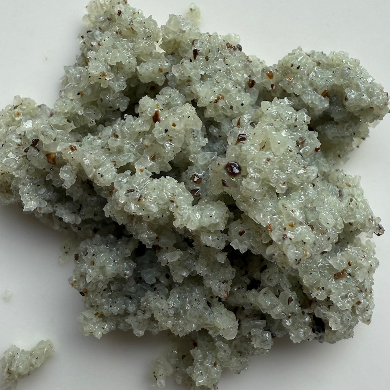 Close-up of a crystal or mineral sample on a white background