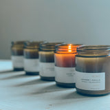 Sealuxe amber glass candle set with one candle burning