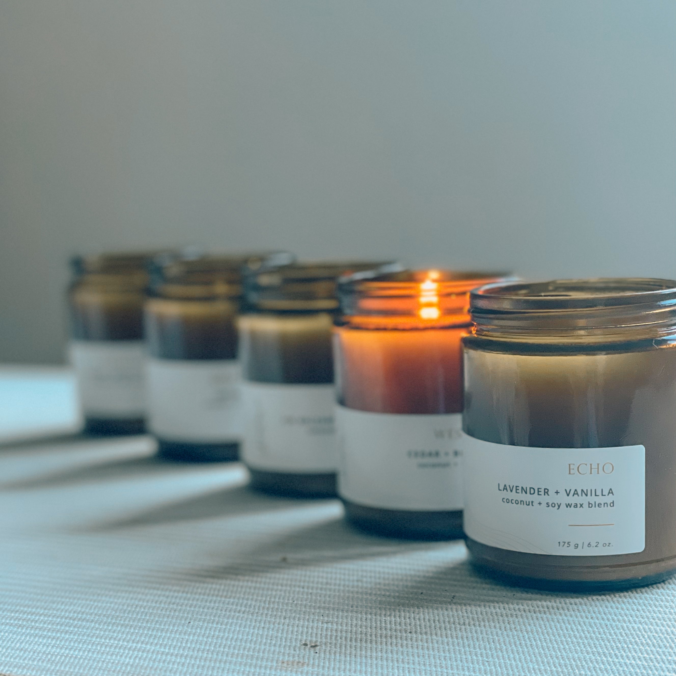 Sealuxe amber glass candle set with one candle burning