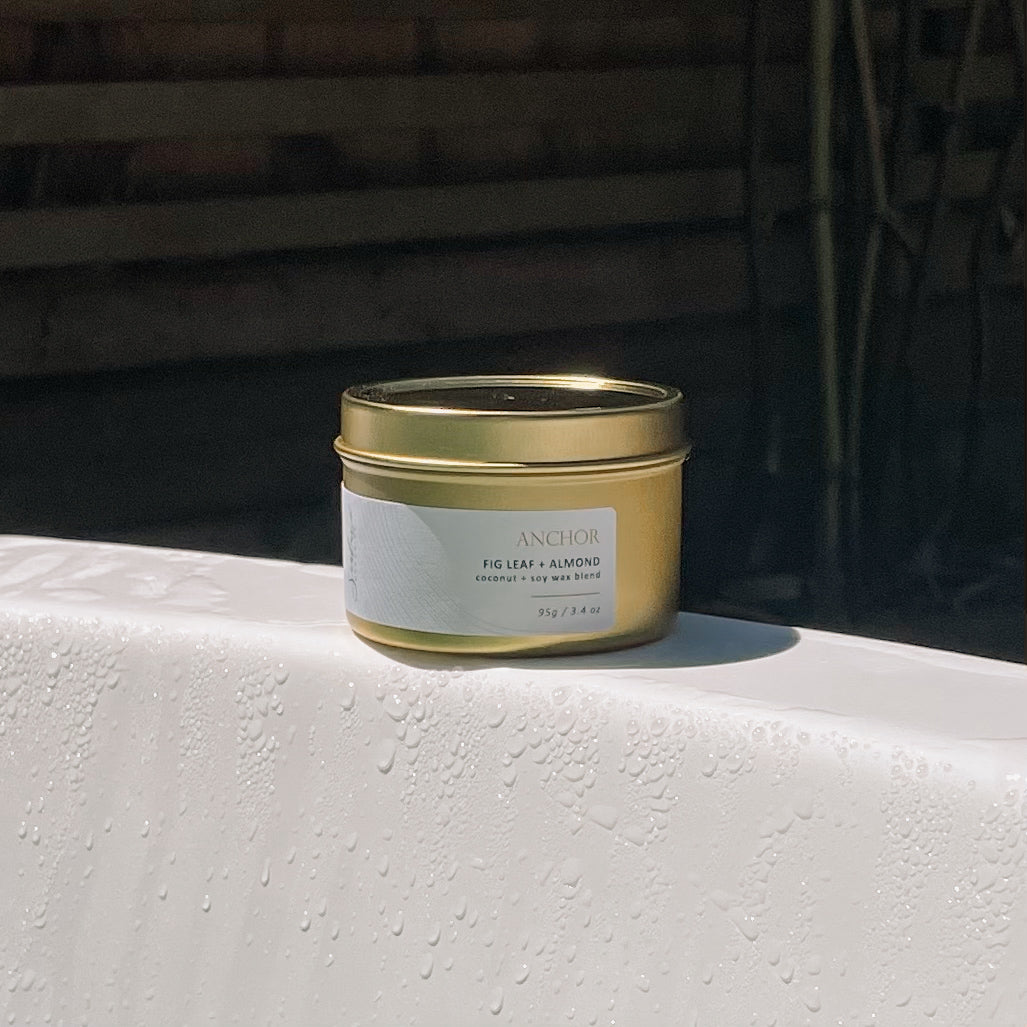 Sealuxe Anchor candle resting on the edge of a bathtub