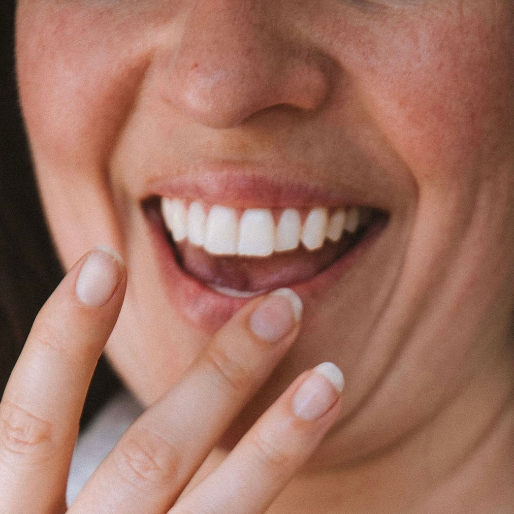 Applying lip balm to lips for moisture and protection