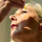 Drops of Sealuxe facial oil applied to the cheek
