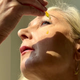 Drops of Sealuxe facial oil applied to the cheek