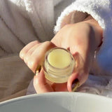 Hand holding a lip balm product from Sealuxe