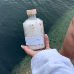 Sealuxe Lemon bath salts with an ocean backdrop