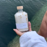 Sealuxe Lemon bath salts with an ocean backdrop