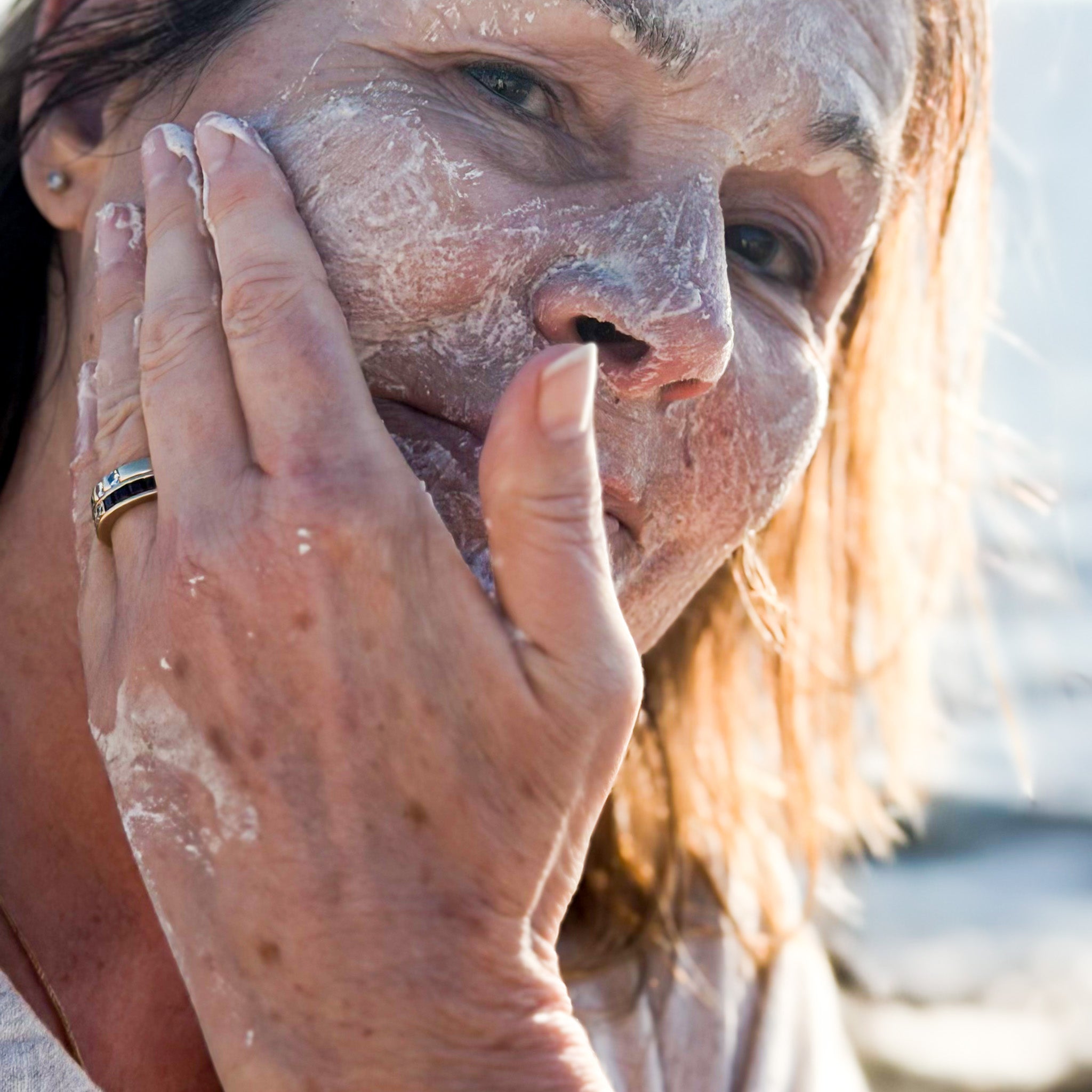 Massaging facial polish with grains onto skin