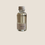 Small bottle of Sealuxe Eucalyptus bubble bath on a wooden surface