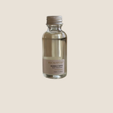 Small bottle of Sealuxe Eucalyptus bubble bath on a wooden surface
