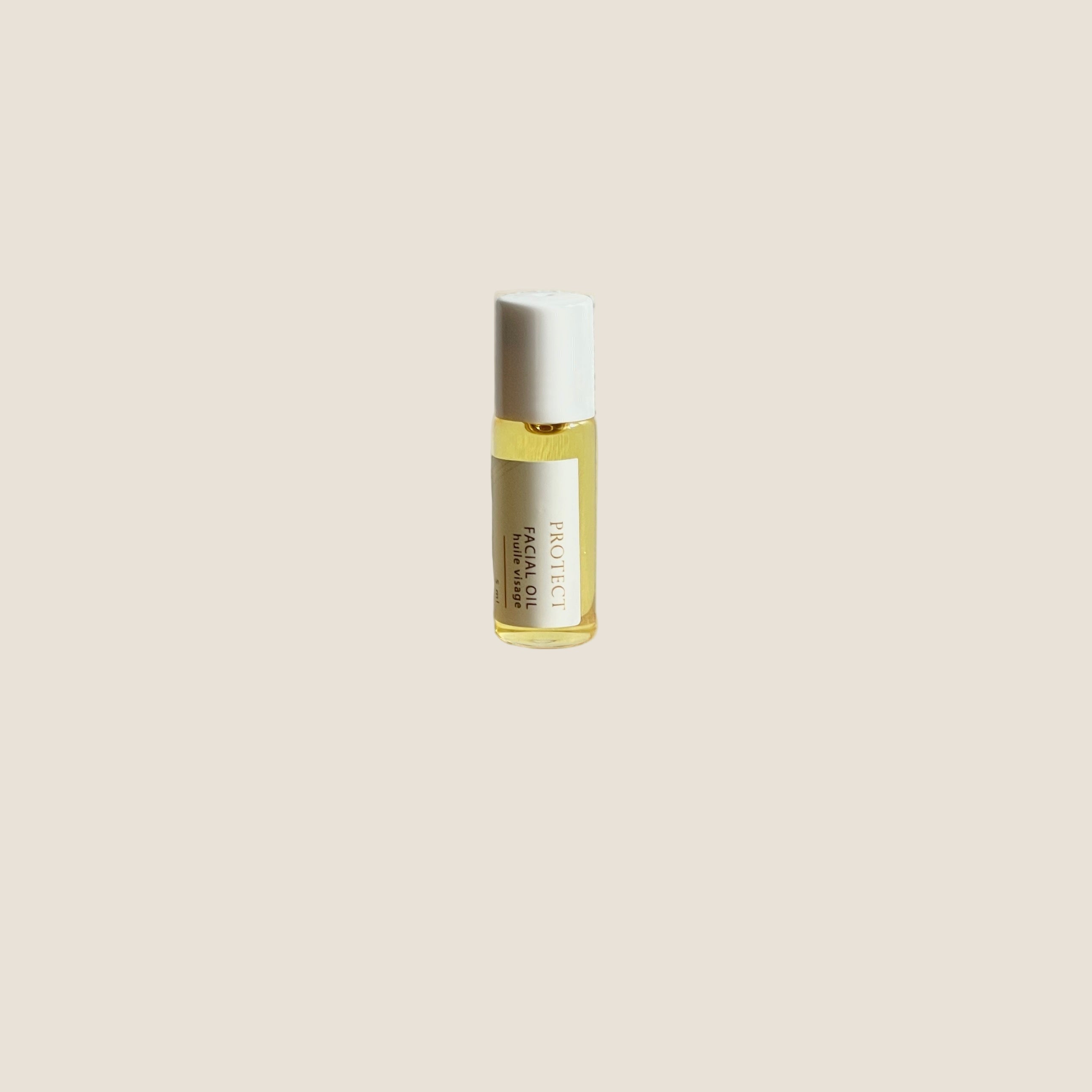 Sealuxe mini Protect facial oil bottle on a wooden surface with a white background