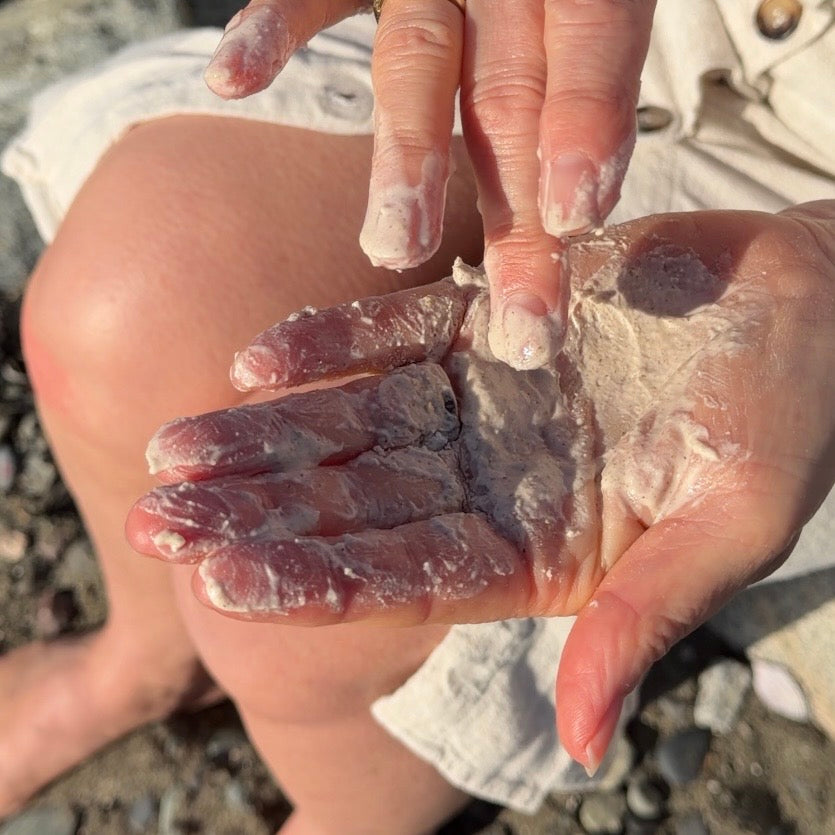 Mixing a small amount of facial polish with water in hands