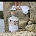 Person standing behind a Sealuxe Forest Bathing bath salts jar