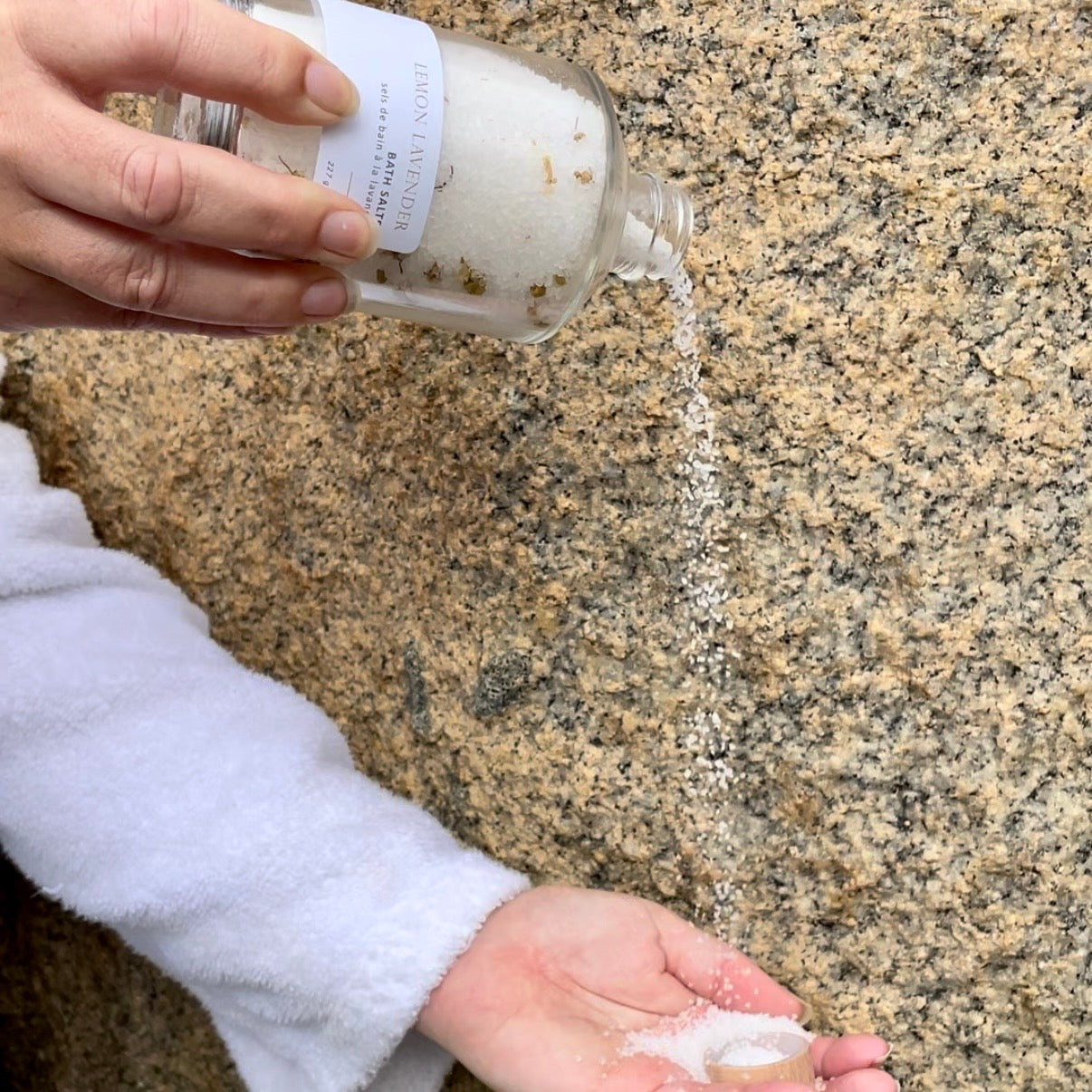 Pouring Sealuxe bath salts into a bath