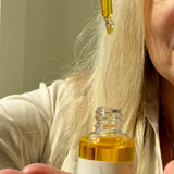 Drops of Sealuxe Protect facial oil dripping from a dropper