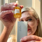 Woman in the background with Sealuxe Protect facial oil in the foreground