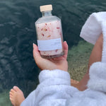 Sealuxe Rose bath salts with an ocean backdrop