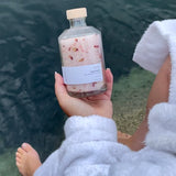 Sealuxe Rose bath salts with an ocean backdrop
