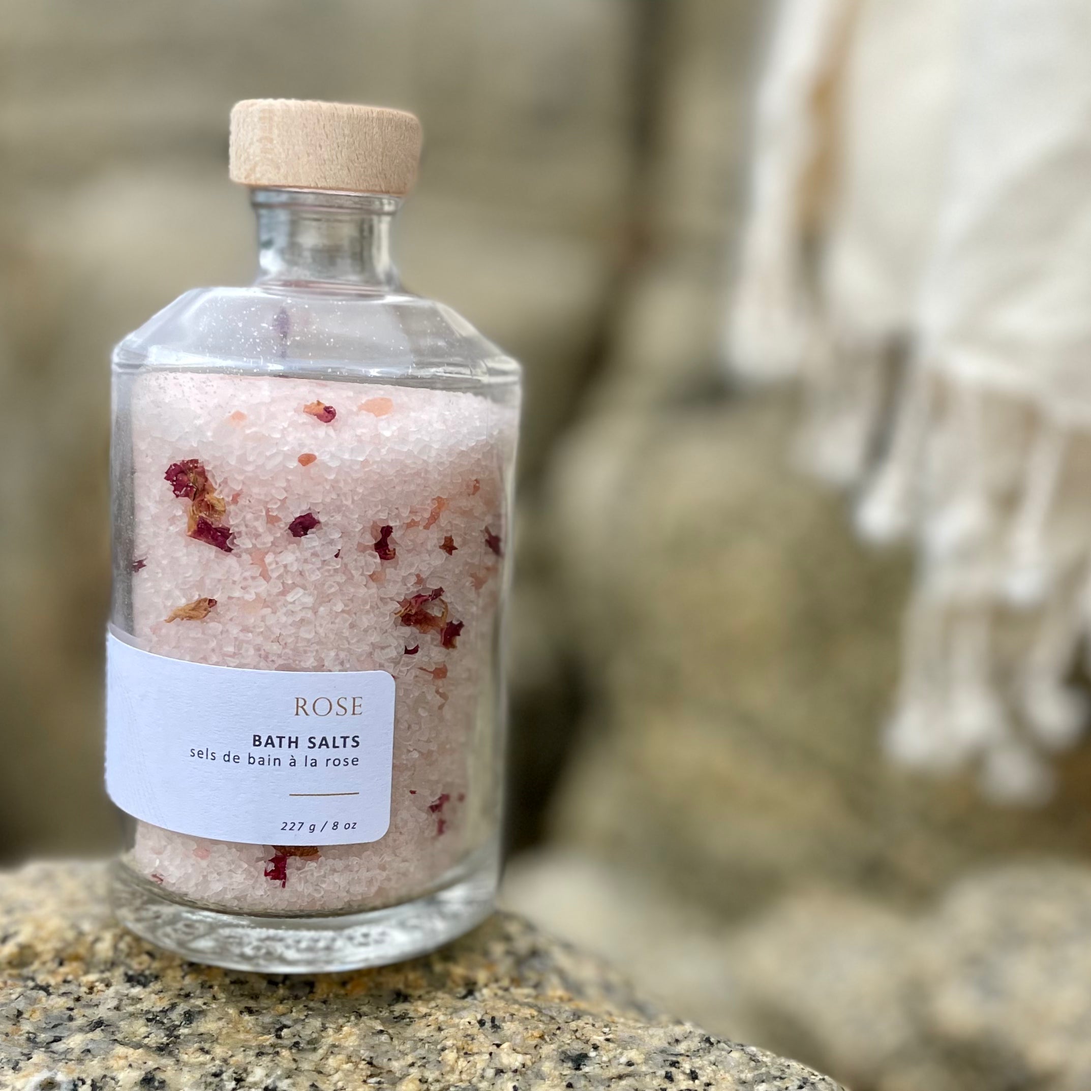 Sealuxe Rose bath salts displayed with a folded towel