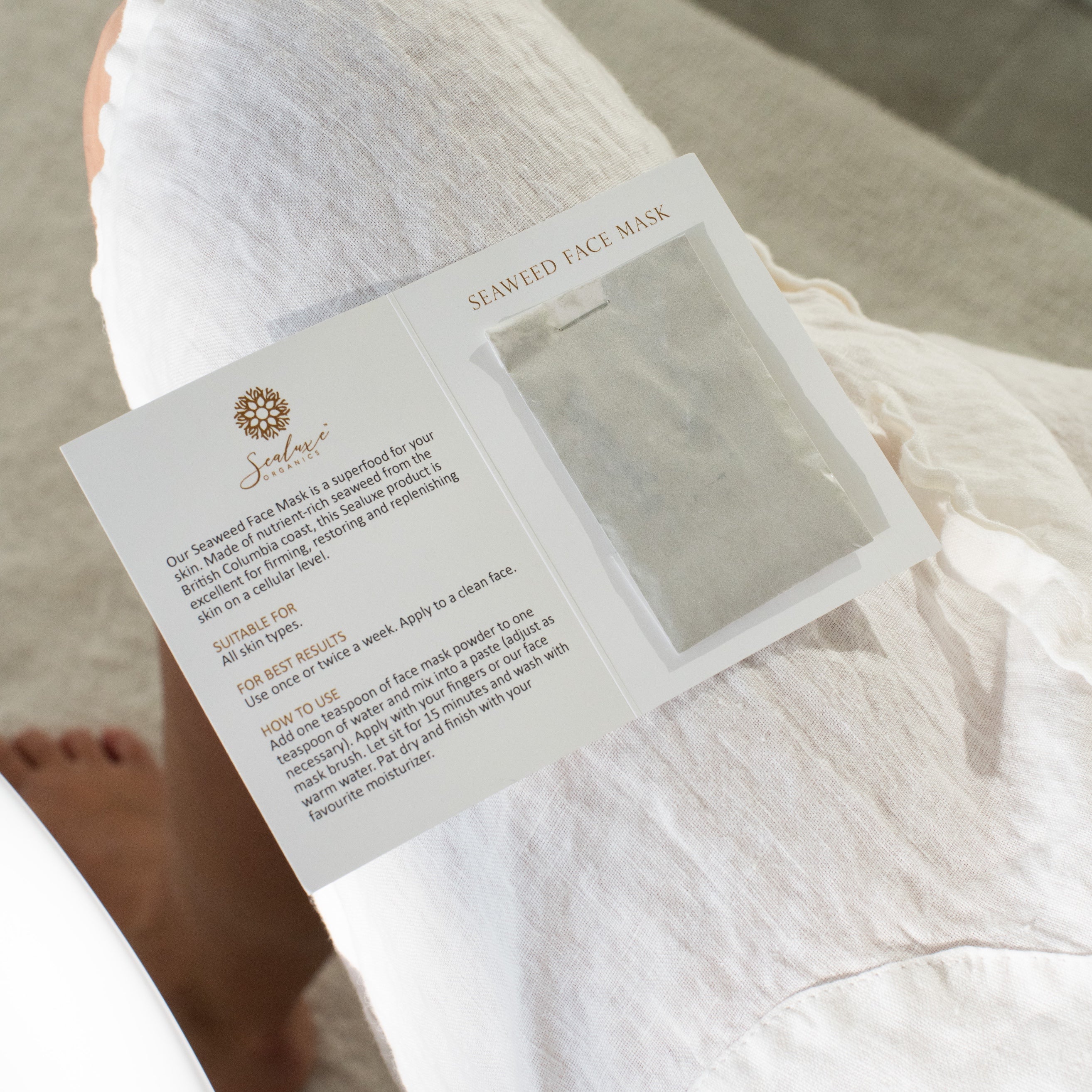 Open package of Sealuxe Seaweed Face Mask with a clear plastic sheet inside on a white surface