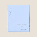 A square white box of Sealuxe Organics Forest Bathing Bath Tea. The box features elegant gold and dark gray text and subtle concentric wave patterns.