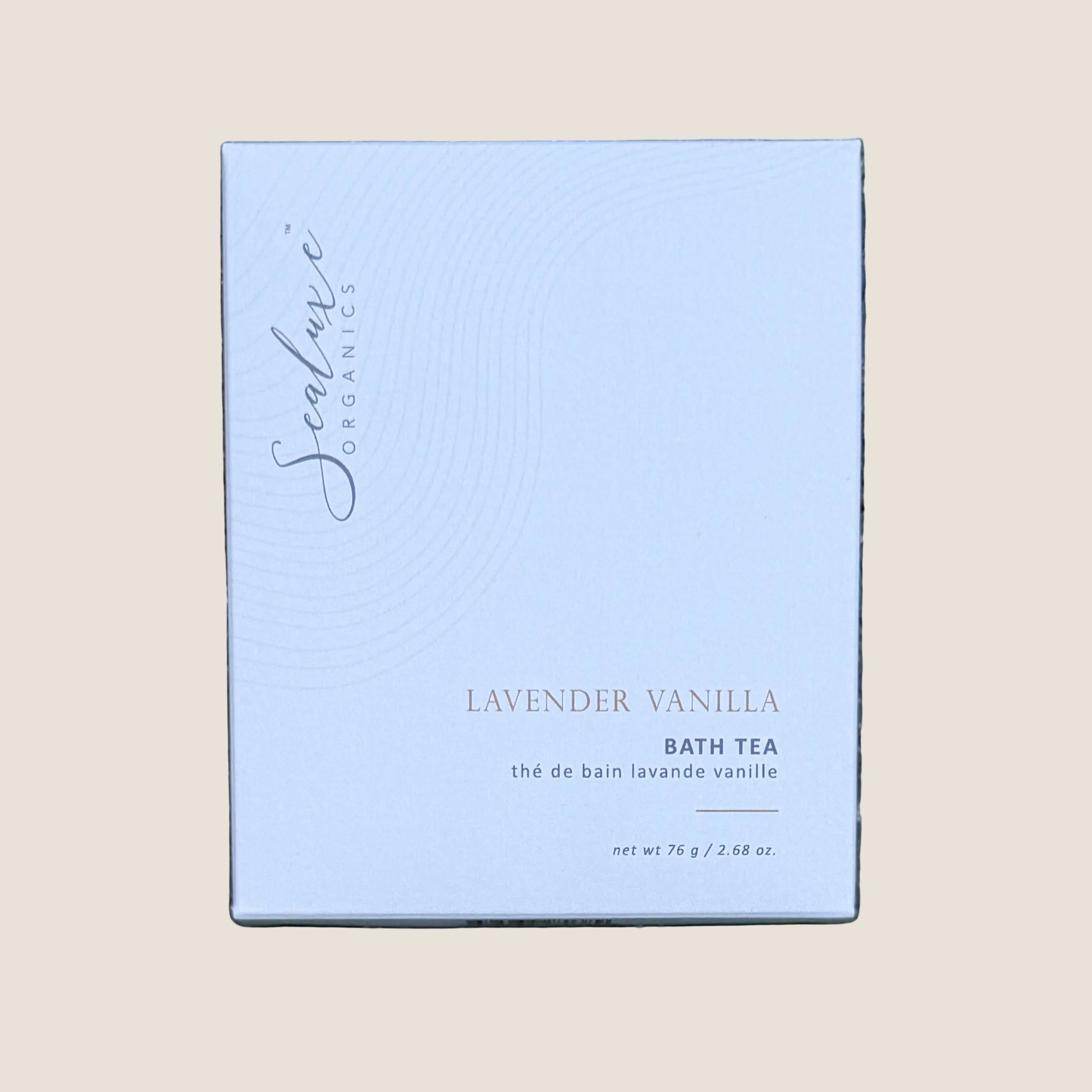 A rectangular box of Sealuxe Lavender Vanilla Bath Tea. The box is a very pale lavender-blue with black script branding and black text, including 'LAVENDER VANILLA BATH TEA' and 'net wt 76 g / 2.