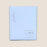 A square white box of Sealuxe Organics Ritual Rose Bath Tea. The box features elegant black cursive branding and gold text indicating the product name and scent.